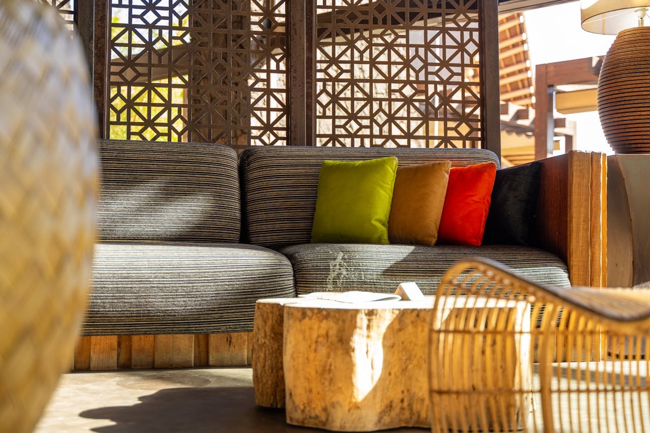 Stylish living room with colorful cushions, wooden elements, and geometric patterns.