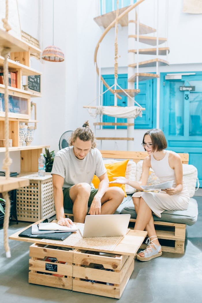 Two young adults collaborating in a stylish, modern office space with a creative interior design.